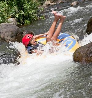a person is laying on a raft in a river