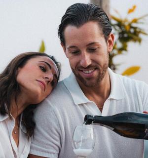 a man and a woman pouring a glass of wine