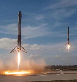 two rockets are launching into the air with smoke