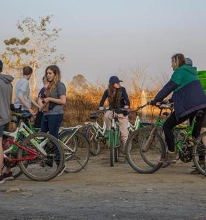 a group of people standing around with their bikes
