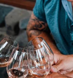 a group of people holding up wine glasses