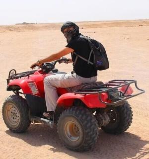 a man on a quad bike in the desert