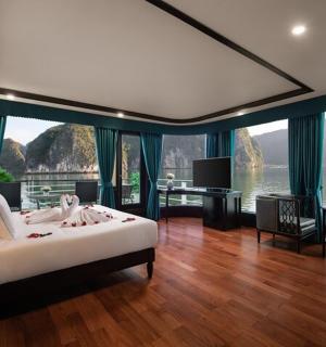 a bedroom with a bed and a view of the water