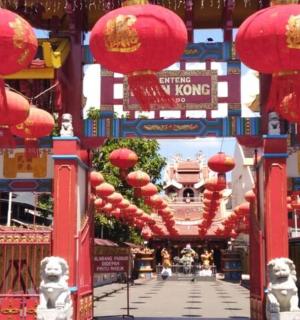 an archway with red lanterns in a street