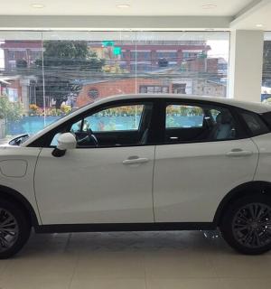 a white car is parked in a room