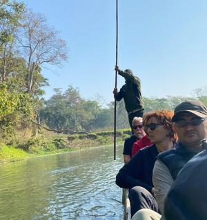 a group of people on a boat on a river