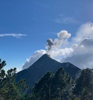 a person taking a picture of a mountain