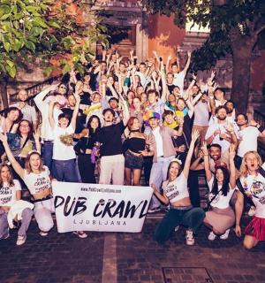 a group of people posing for a picture with their hands in the air
