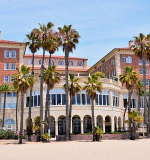 a large building with palm trees in front of it
