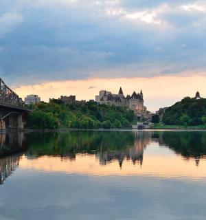 a view of a river with a bridge and buildings