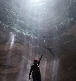 a person standing in the middle of a cave