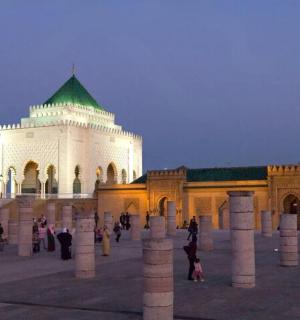 a large white building with a green roof