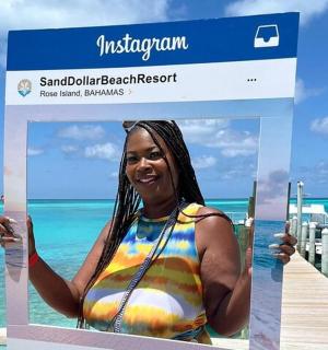a woman in a swimsuit holding up a sign