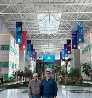 two men are standing in a large building