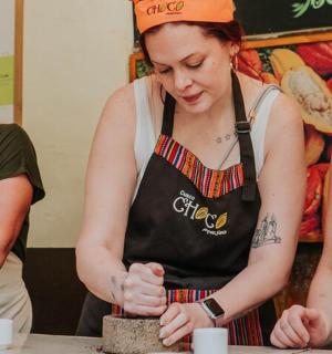 two women standing in a kitchen preparing food