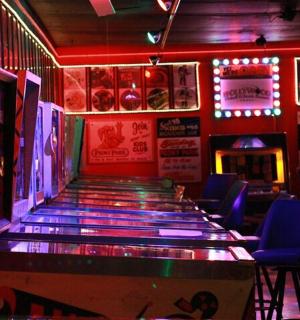 a bar with blue chairs and a dance floor