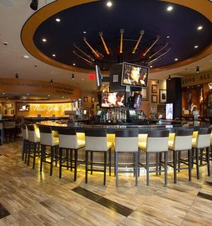 a bar in a restaurant with white chairs