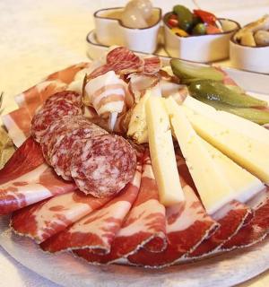 a plate of cheese and other foods on a table