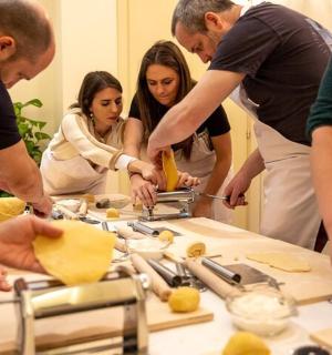a group of people standing around a table preparing food