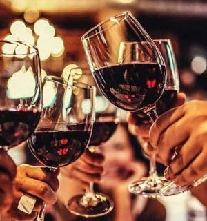 a group of people holding up wine glasses