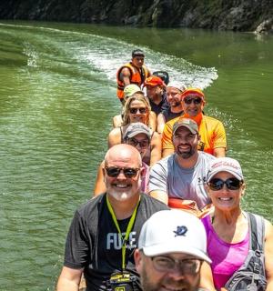 a group of people on a boat in the water