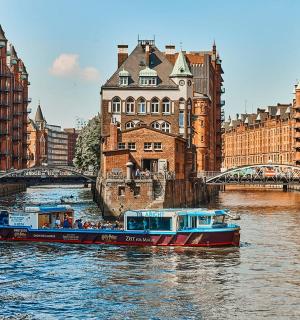 a boat traveling down a river in a city