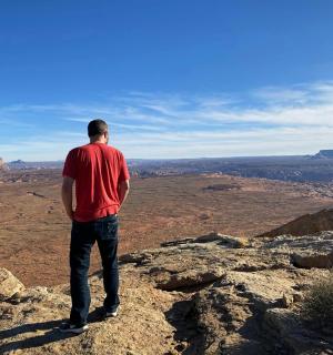 a man standing on the edge of a mountain