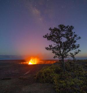 a fire in the middle of a field at night