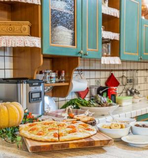 a kitchen counter with a pizza on a cutting board