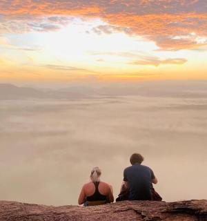 a group of people sitting on top of a mountain