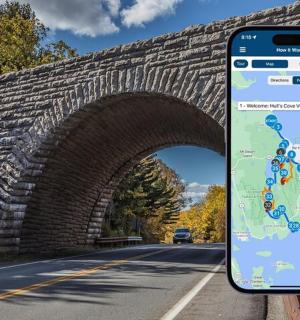 a cell phone sitting on the side of a brick bridge