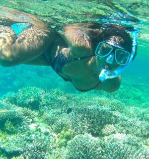 a man in sunglasses swimming in the water