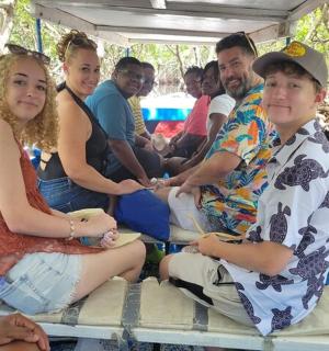 a group of people sitting in the back of a boat