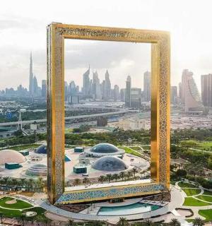 a giant mirror frame in front of a city