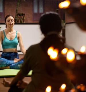 a woman sitting in a chair in a yoga class