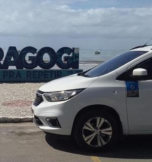 a white car parked in a parking lot near the beach