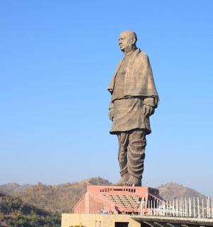 a statue of a man standing on top of a building