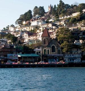 a town on a hill next to a body of water