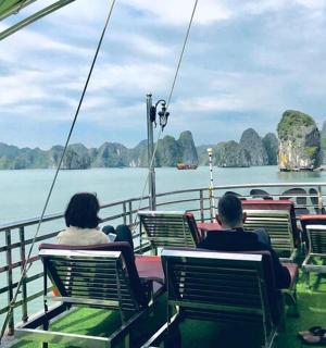 two people sitting on a boat in the water