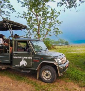 a group of people riding in a safari vehicle