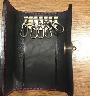 a black case with four pairs of scissors in it
