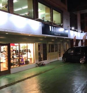 a car parked in front of a store at night