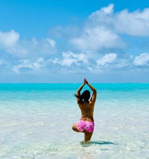 a woman standing in the water on the beach