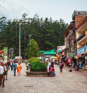a group of people walking down a street in a city