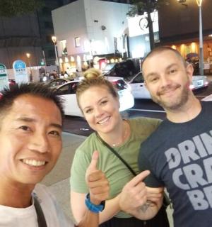 skupina tří lidí ukazuje palec nahoru