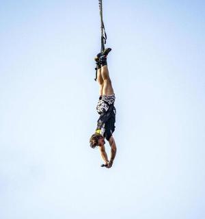 a person is hanging from a rope