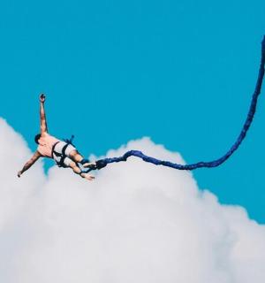 a man is on a rope in the sky