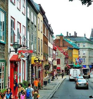 a busy city street with people walking down the street
