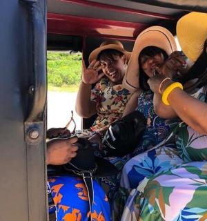 a group of people sitting in the back of a bus