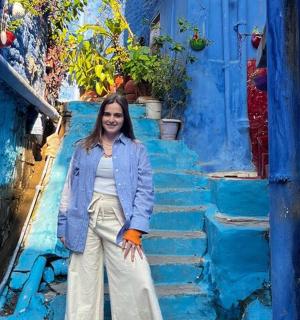 a woman sitting on a set of blue stairs